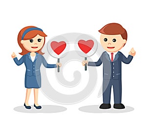 Business couple standing with love sign