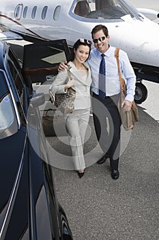 Business Couple Standing Together At Airfield