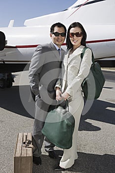 Business Couple Standing Together At Airfield