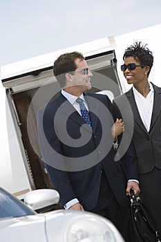 Business Couple Standing Together At Airfield