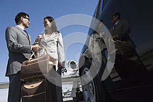 Business Couple Standing Together At Airfield photo