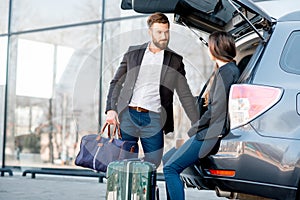 Business couple traveling by car