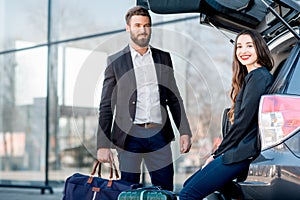 Business couple traveling by car