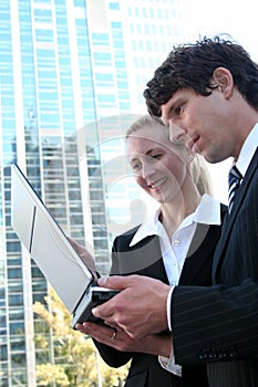 Business couple using laptop