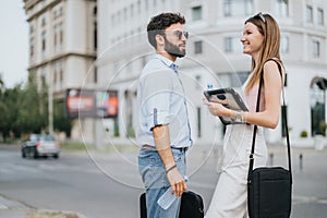 Business couple walks city center, discussing new ideas and expansion plans. Successful executives strategizing for