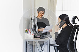 Business couple working on computer together at home.