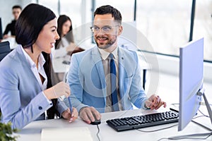 Business couple working together on project at modern startup office.