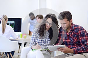 Business couple working together on project at modern startup office