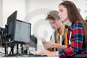 Business couple working together on project using tablet and desktop computer at modern open plan startup office