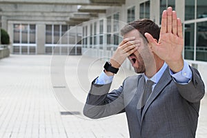 Business covering his eyes to avoid reality