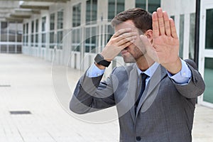 Business covering his eyes to avoid reality