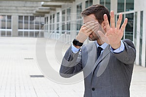 Business covering his eyes to avoid reality