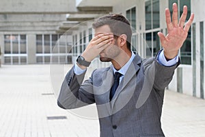 Business covering his eyes to avoid reality