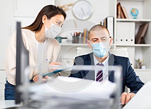 Business coworkers in fase masks discussing new ideas