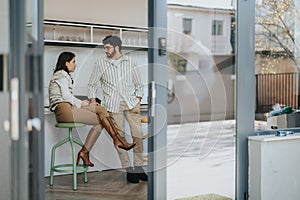 Business coworkers taking a break, having a conversation over coffee and tea.