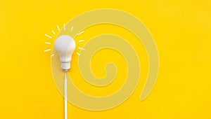 Business creativity and inspiration concepts with lightbulb and pencil on yellow background