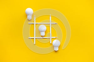 Business creativity and inspiration concepts with lightbulb and pencil on yellow background