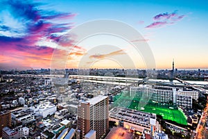 Panoramic modern city skyline bird eye aerial view under dramatic sunset glow in Tokyo, Japan