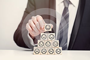 Business customer feedback concept, wooden cubes, happy and sad emotions