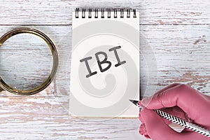 Business Customer Management Analysis Service. IBI in a notebook by hand with a pencil photo