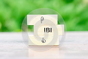 Business Customer Management Analysis Service. IBI on a wooden bar on a table on a green background photo