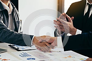 Business deal with business people shaking hands in a conference room