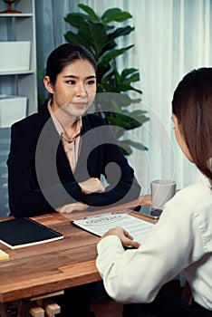 Business deal meeting, businesswomen reviewing terms and condition. Equilibrium