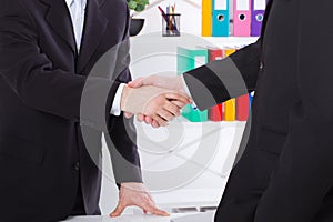 Business deal. Partnership meeting concept with successful businessmen handshaking at office background. Selective focus