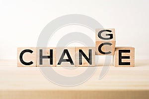 Surreal abstract geometric floating wooden cube with word CHANGE and CHANCE concept on wood floor and white background