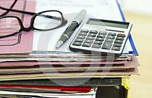 Business desk with file and eyeglasses