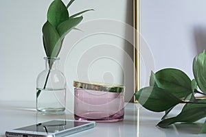 Business desktop with copy space glass vase leaves