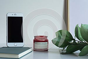Business desktop with smartphone copy space candle