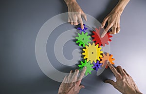 Business development, teamwork and collaboration concept - people connecting gears. top view copy space