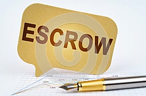 On the business diagram is a pen and a sign with the inscription - ESCROW