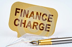 On the business diagram is a pen and a sign with the inscription - Finance Charge