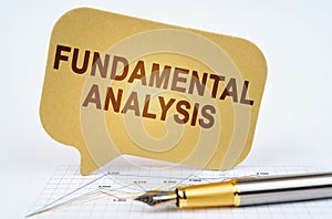 On the business diagram is a pen and a sign with the inscription - FUNDAMENTAL ANALYSIS