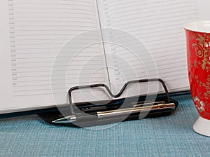 Business diary with pen on bookstand photo