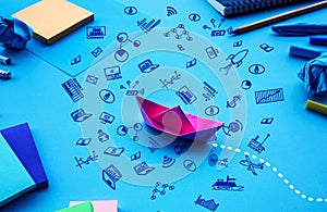 Business direction or goal concepts with boat paper and business doodle icon on worktable background photo