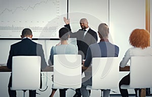 Business discussions. a mature businessman giving a presentation in the boardroom.