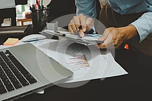 Business documents  graphs and charts marketing and sales reports. Business growth with computer laptop on desk. work for home