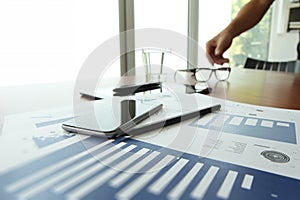 Business documents on office table with smart phone