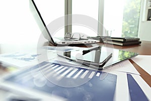 Business documents on office table with smart phone