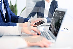 Business documents on office table with smart phone and laptop computer