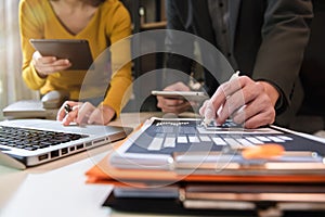 Business documents on office table with smart phone, tablet and laptop computer and graph with social network diagram.