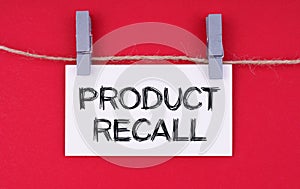 A business card with the inscription - PRODUCT RECALL. Isolated on red background photo
