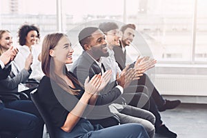 Business education. Colleagues clapping hands at seminar