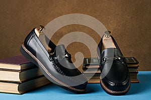 Business education concept with mens black leather shoes, close-up.