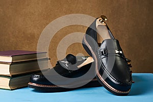 Business education concept with mens black leather shoes, close-up.