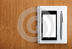 Business and education concept - smartphone and notepad