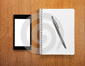 Business and education concept - smartphone and notepad